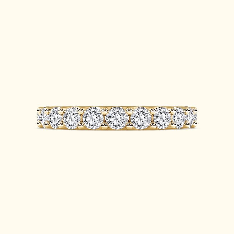 Gold band ring set with multiple round-cut diamonds.