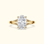 Oval diamond ring with a gold band and elegant side detailing.