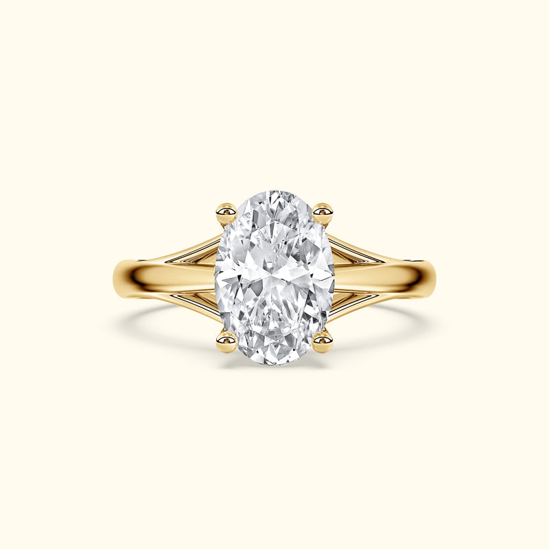 Oval diamond ring with a gold band and elegant side detailing.