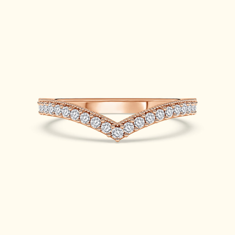 V-shaped rose gold ring adorned with sparkling diamonds along the band.