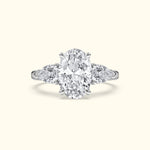 Oval diamond engagement ring with sidestones, set in a polished white gold band.