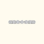 A delicate diamond band featuring several round, sparkling diamonds set in a sleek metal setting.