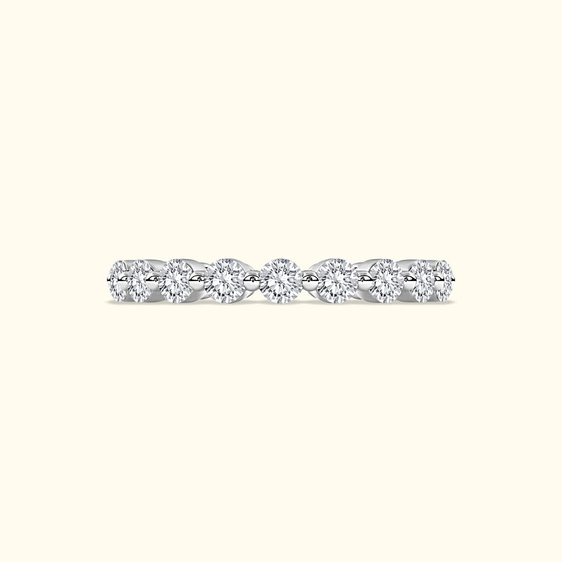 A delicate diamond band featuring several round, sparkling diamonds set in a sleek metal setting.