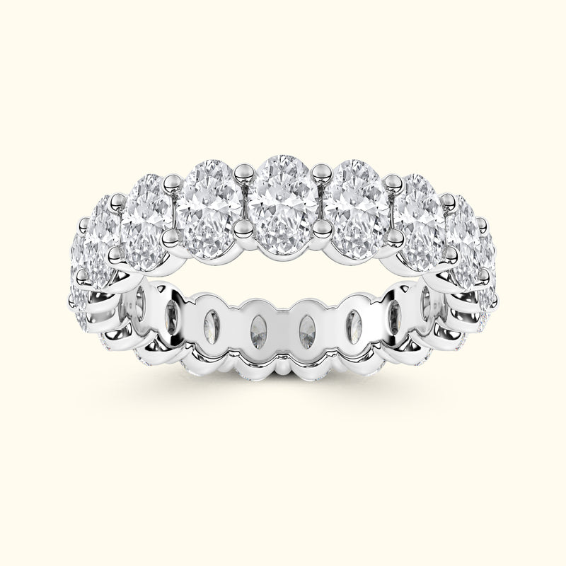 A silver band ring set with multiple oval-cut diamonds in a continuous circle.
