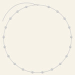 Silver necklace featuring evenly spaced circular diamond accents.
