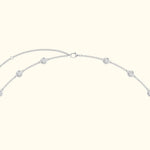 Silver necklace with circular decorative elements evenly spaced along the chain.