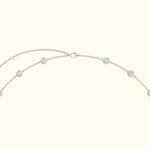 Delicate silver necklace with circular pendant details and a simple clasp.