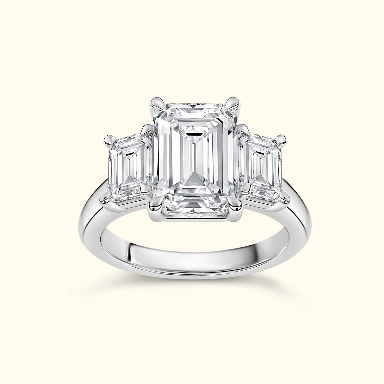 Three-stone emerald cut diamond ring on a polished band.