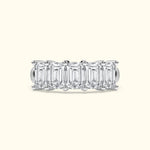 Five emerald-cut diamonds set in a sleek silver band.