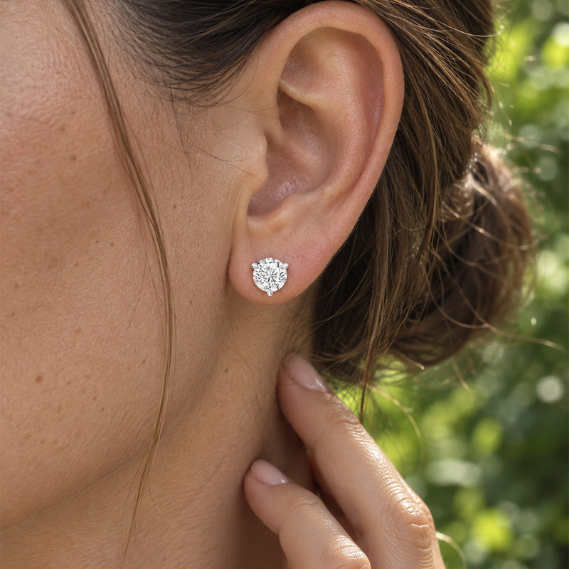2.00 CTW round lab-grown diamond stud earrings in a signature three-prong martini-style 14kt white gold setting.