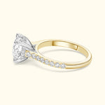 A two-toned engagement ring featuring a large round diamond centerpiece and smaller diamonds along the band.