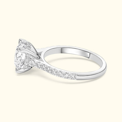 Elegant diamond engagement ring with a sparkling center stone and a band adorned with smaller diamonds.