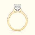 Elegant gold and platinum engagement ring featuring a sparkling square diamond center and smaller side stones.