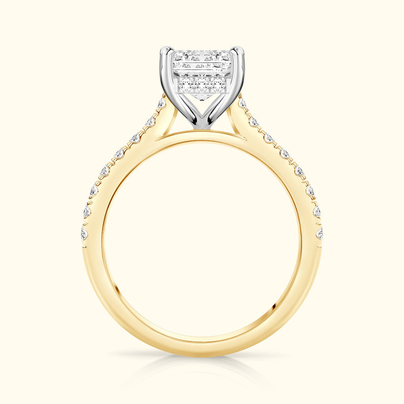 Elegant gold and platinum engagement ring featuring a sparkling square diamond center and smaller side stones.