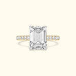 Emma-shaped diamond ring with a gold and silver band adorned with smaller diamonds.