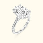 Brilliant oval-cut diamond engagement ring with a sparkling band of smaller diamonds.