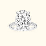 Oval diamond engagement ring with a sleek band and sparkling side stones.