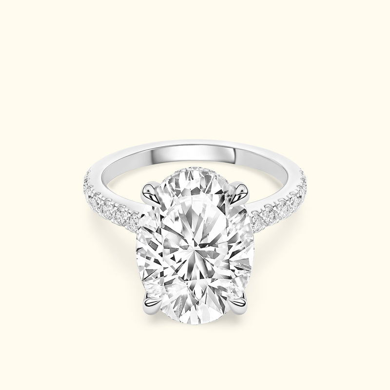 Elegant oval diamond engagement ring with a sparkling pavé band.