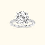 Elegant solitaire diamond ring with a round center stone and delicate band accents.