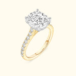 Yellow gold engagement ring featuring a large round diamond and smaller diamonds along the band.