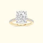 Cushion-cut diamond ring with a gold band and smaller diamonds along the sides.