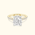 Cushion-cut diamond ring with a yellow gold band and sparkling side stones.
