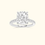 Cushion-cut diamond ring set in a white gold band, adorned with smaller diamonds.