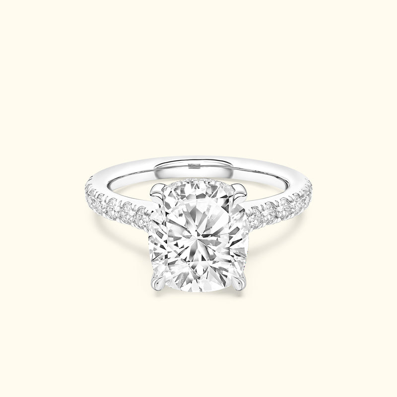 Solitaire diamond ring with a round center stone and diamond-accented band.