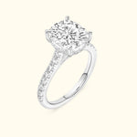 Elegant silver engagement ring featuring a large round diamond and smaller diamonds along the band.
