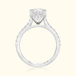 Diamond engagement ring with a square center stone and smaller diamonds along the band.
