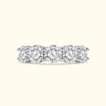 Five round diamonds set in a sleek white gold band with a polished finish.