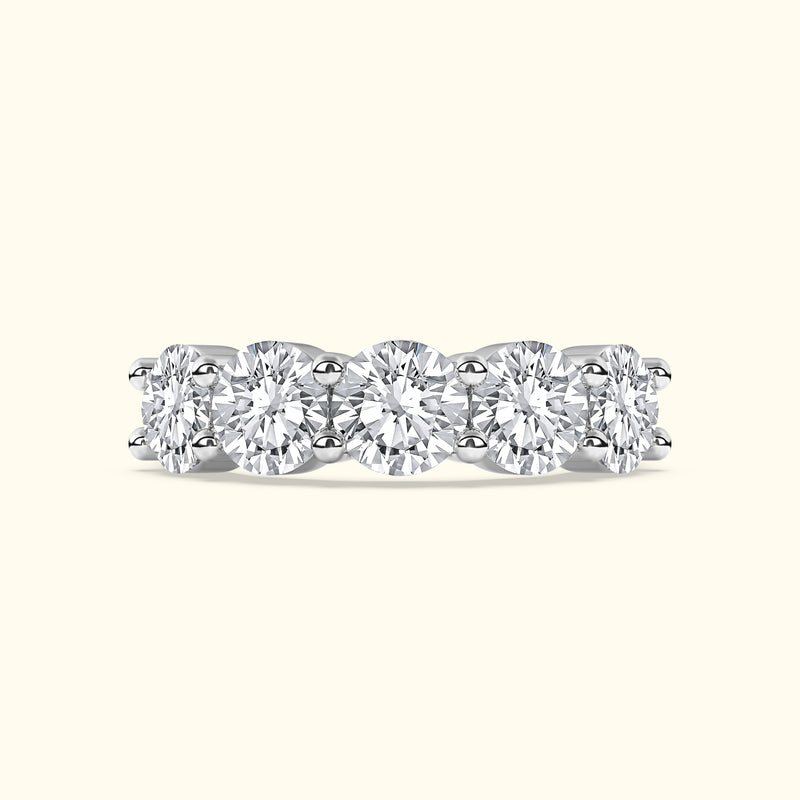 Five round diamonds set in a sleek white gold band with a polished finish.