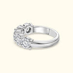 Three-stone diamond ring with a polished silver band.