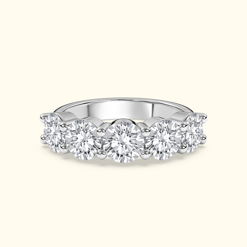 Elegant diamond band featuring five round brilliant stones set in white gold.