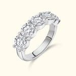 Five-stone diamond ring with a polished silver band, showcasing brilliant round diamonds.