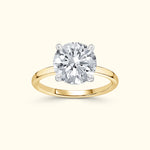 Solitaire engagement ring featuring a large round diamond set in a yellow gold band.
