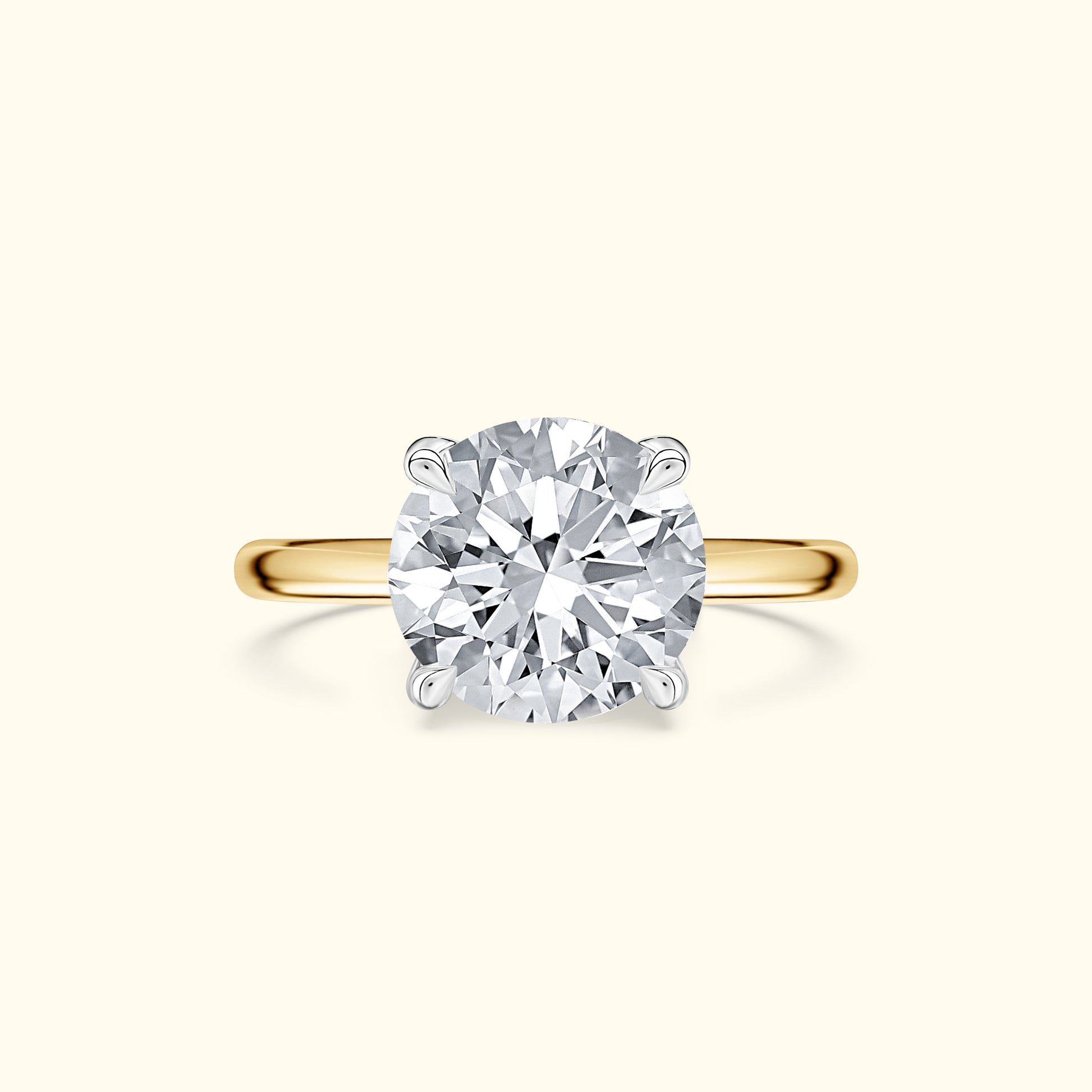 Round diamond engagement ring set in a gold band.