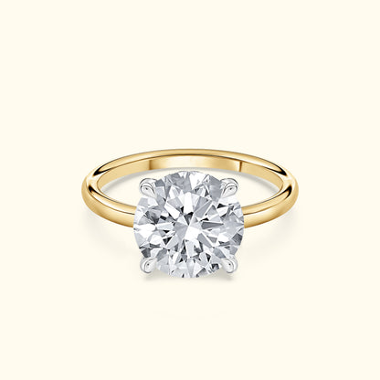 Classic solitaire engagement ring featuring a round brilliant diamond on a yellow gold band.