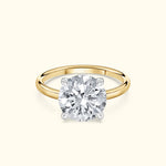 Classic solitaire diamond ring with a round diamond set on a yellow gold band.