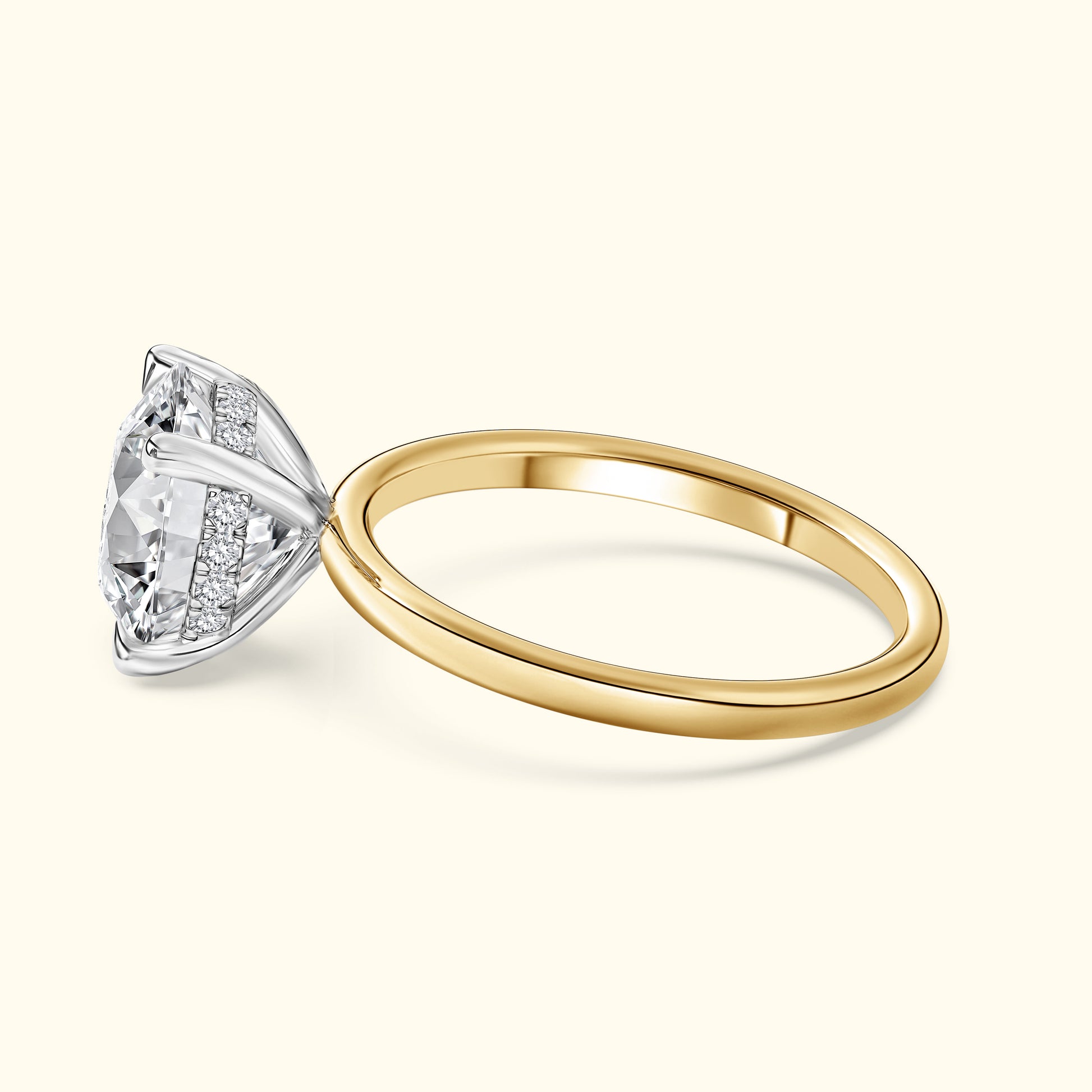 Elegant yellow gold ring with a large diamond and delicate silver band embellishments.