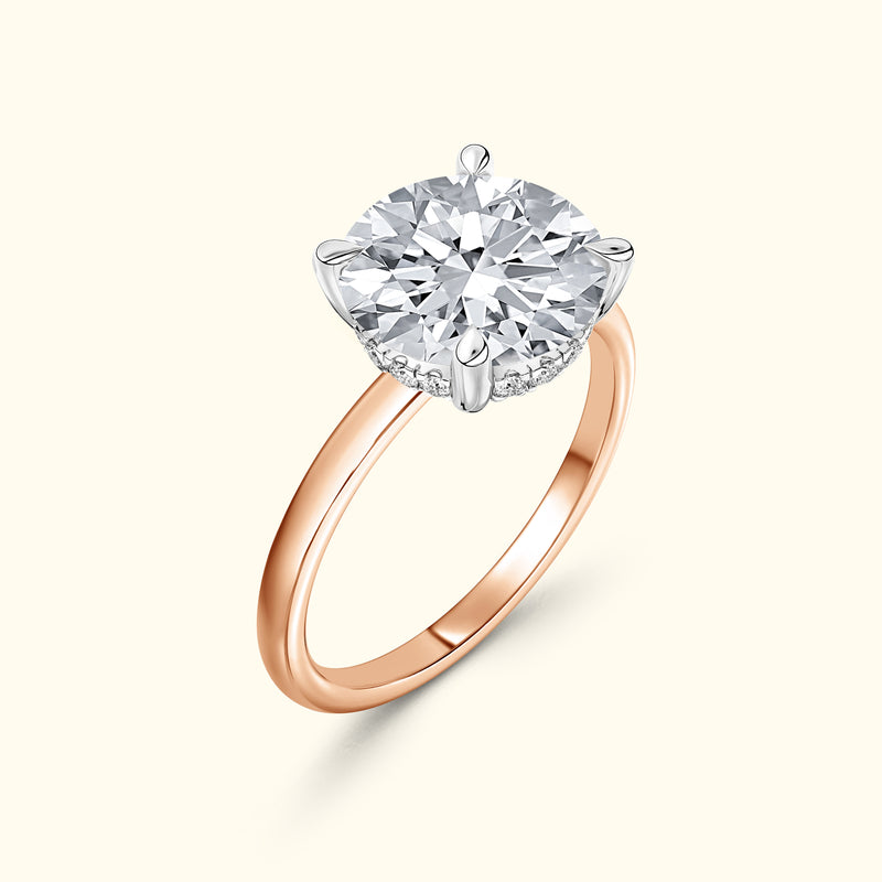 Rose gold engagement ring featuring a large round diamond set in a silver prong.
