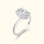 Oval diamond engagement ring with a polished silver band.