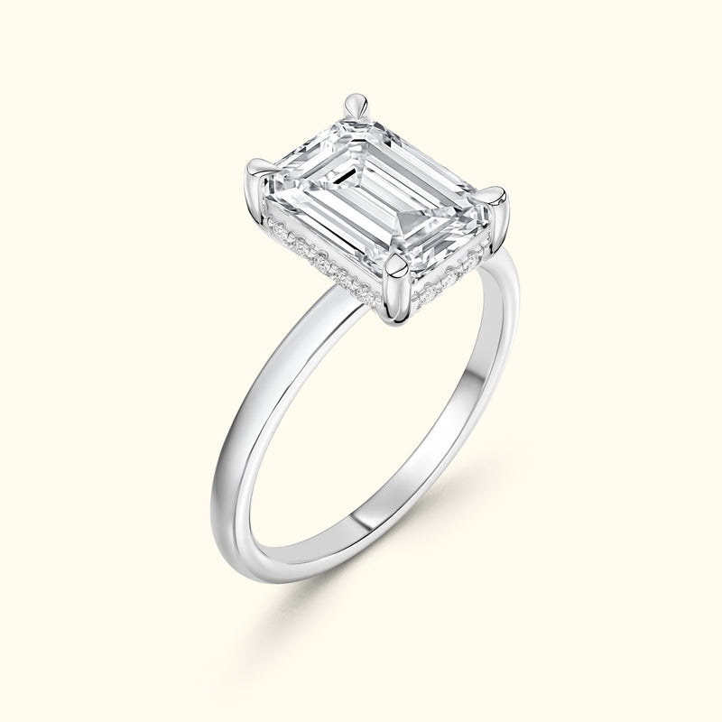 Elegant solitaire ring featuring an emerald-cut diamond set in a sleek silver band.
