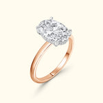 Rose gold ring featuring a large oval diamond with a silver setting.