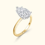 Elegant pear-shaped diamond ring with a gold band and white gold setting.