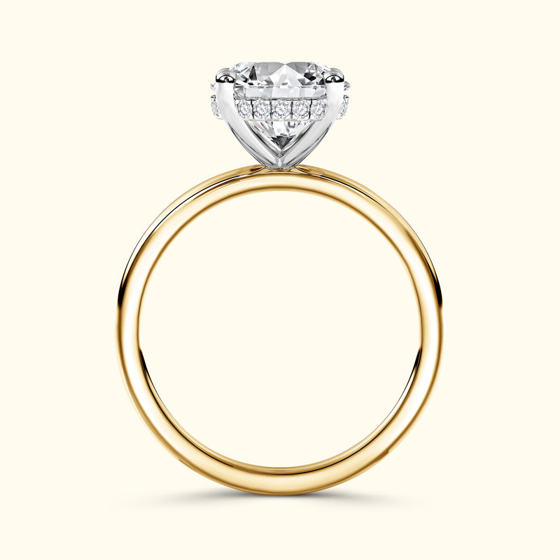 A diamond engagement ring with a gold band and a silver setting, showcasing a large gemstone.