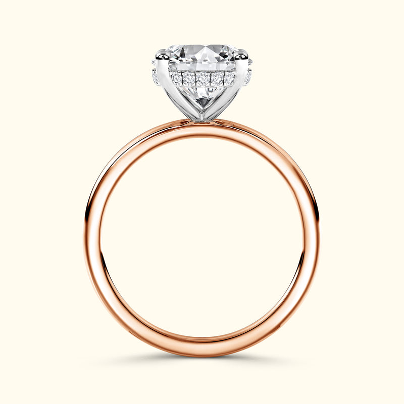 Solitaire engagement ring featuring a round diamond atop a rose gold band.