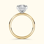 A diamond engagement ring featuring a large round cut stone on a gold band.