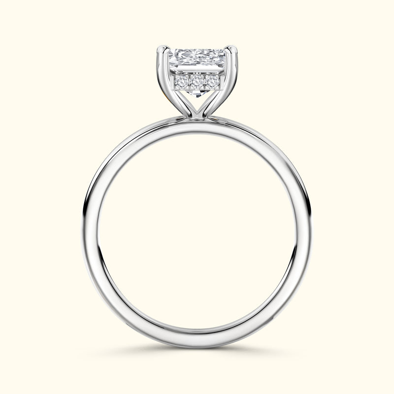 Elegant silver engagement ring featuring a square-cut diamond and side stones.
