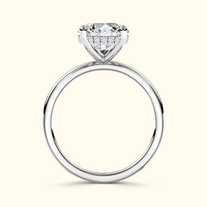 Solitaire ring with a large round diamond and smaller sidelights on a smooth silver band.